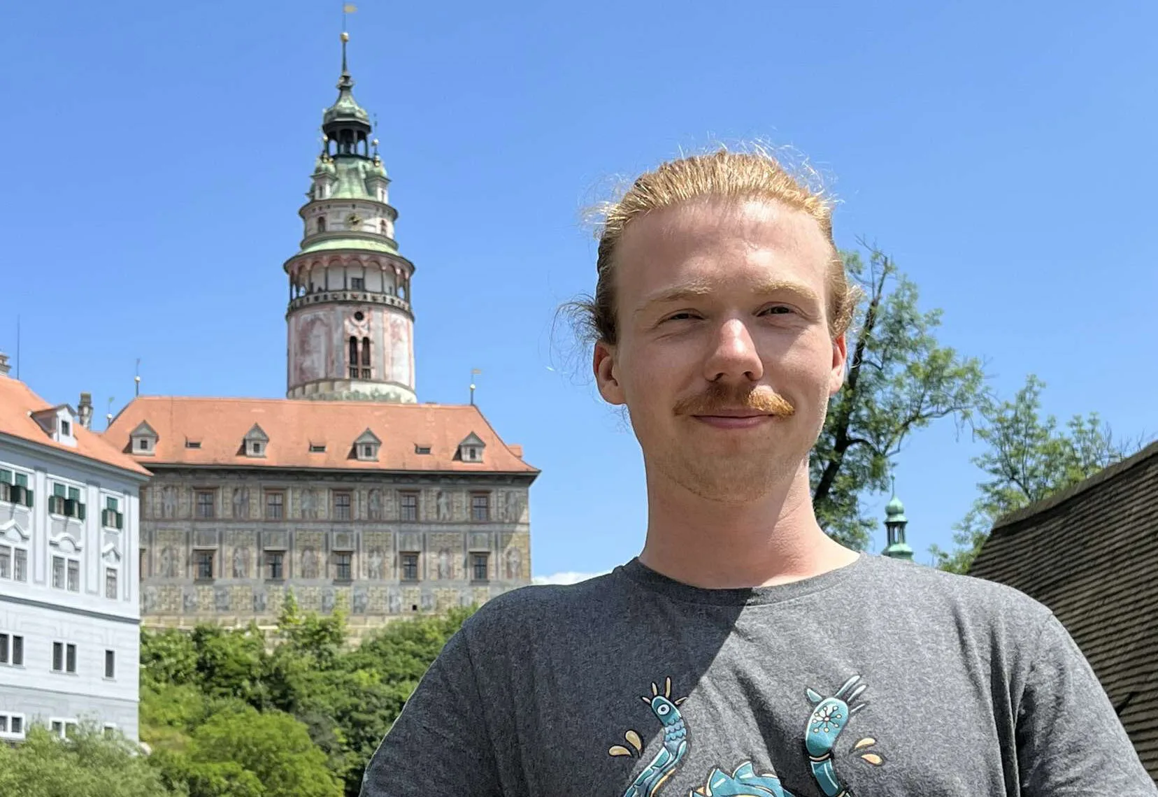 Game & UX Designer student Fredrik Borg in front of a castle.
